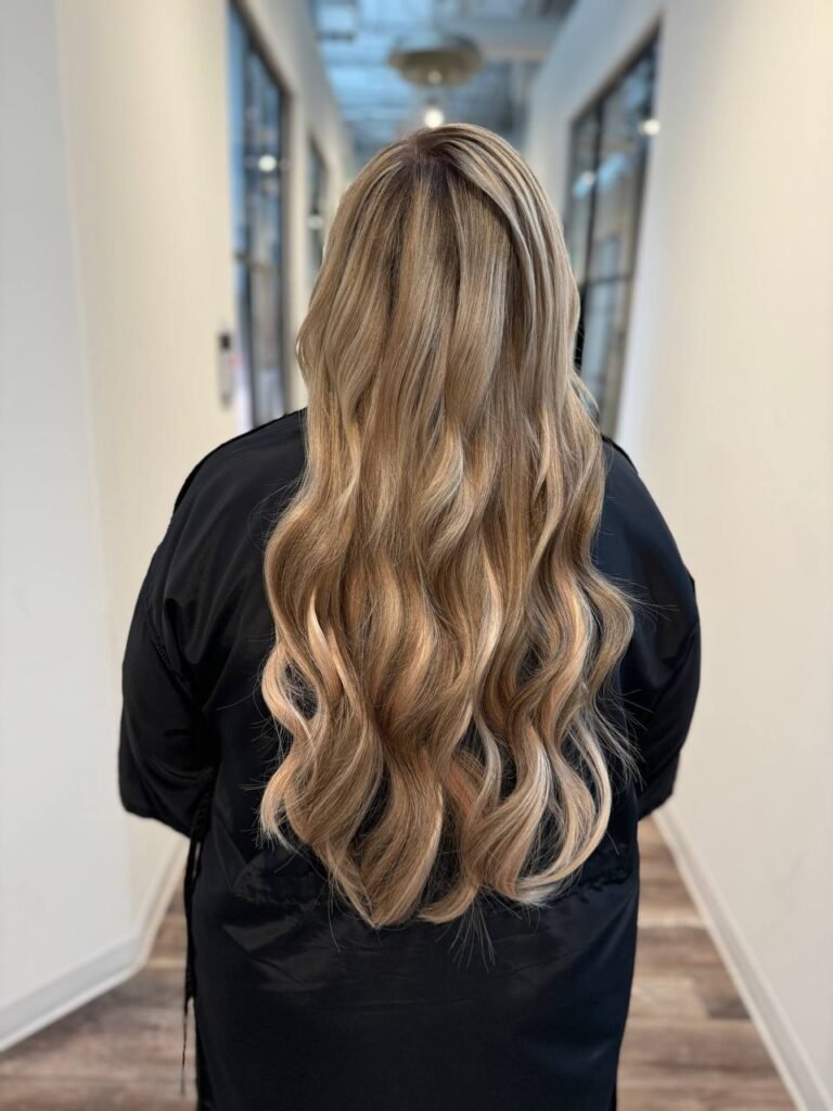 Balayage hair extension with naturally blended tones, creating a soft and sun-kissed effect.